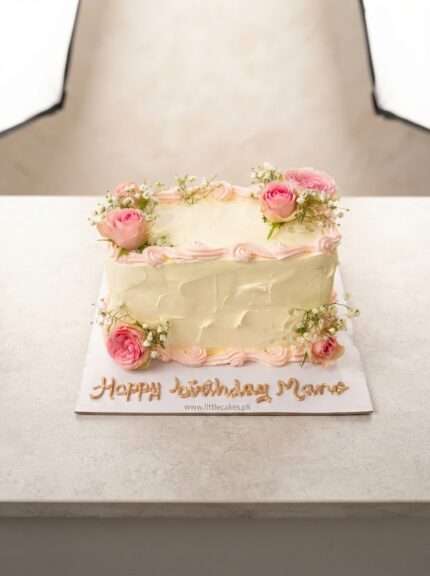 Rectangular birthday cake with pink flowers and baby breath flowers