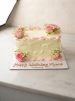 Rectangular birthday cake with pink flowers and baby breath flowers